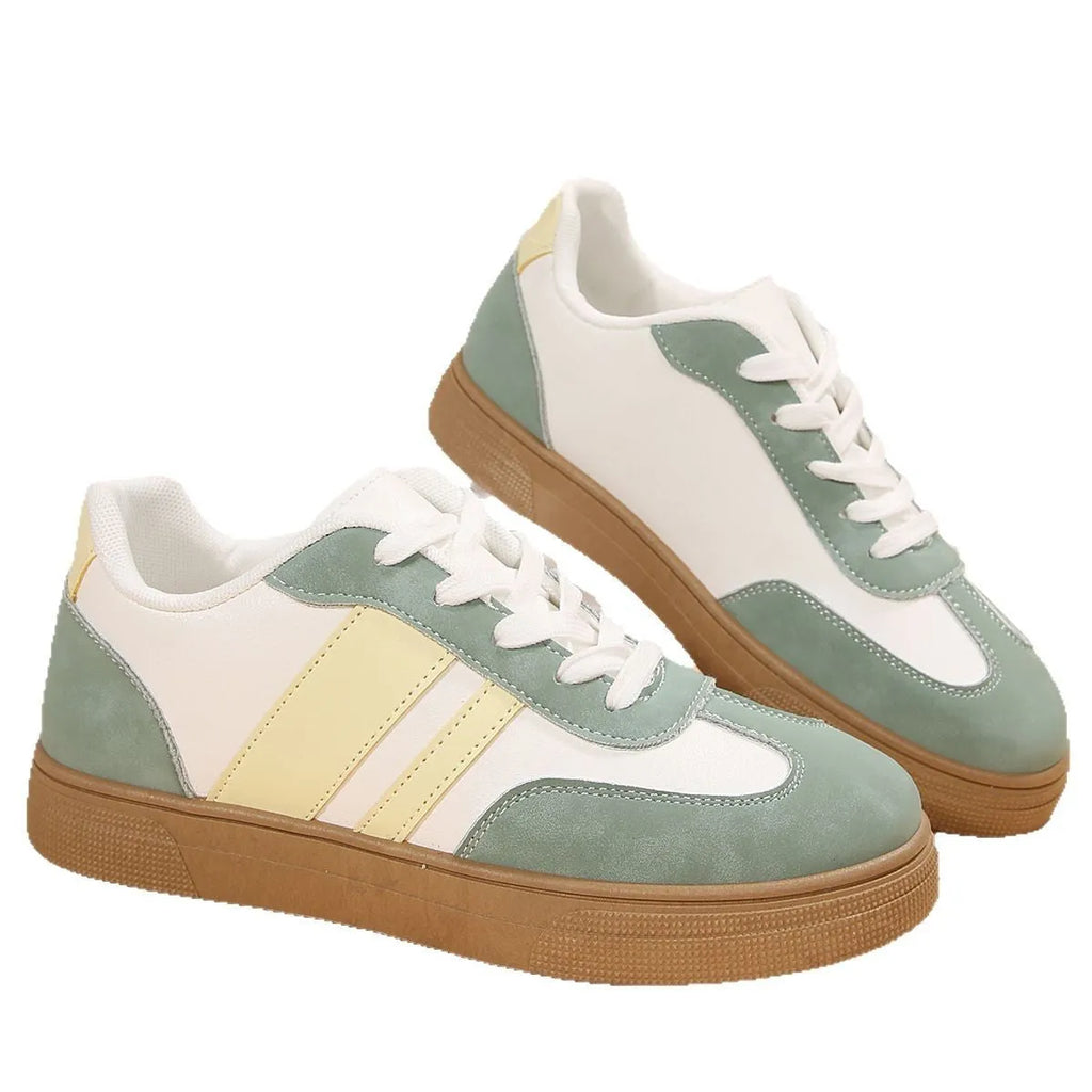 Green women's retro sports pumps with cross straps and leather stitching details