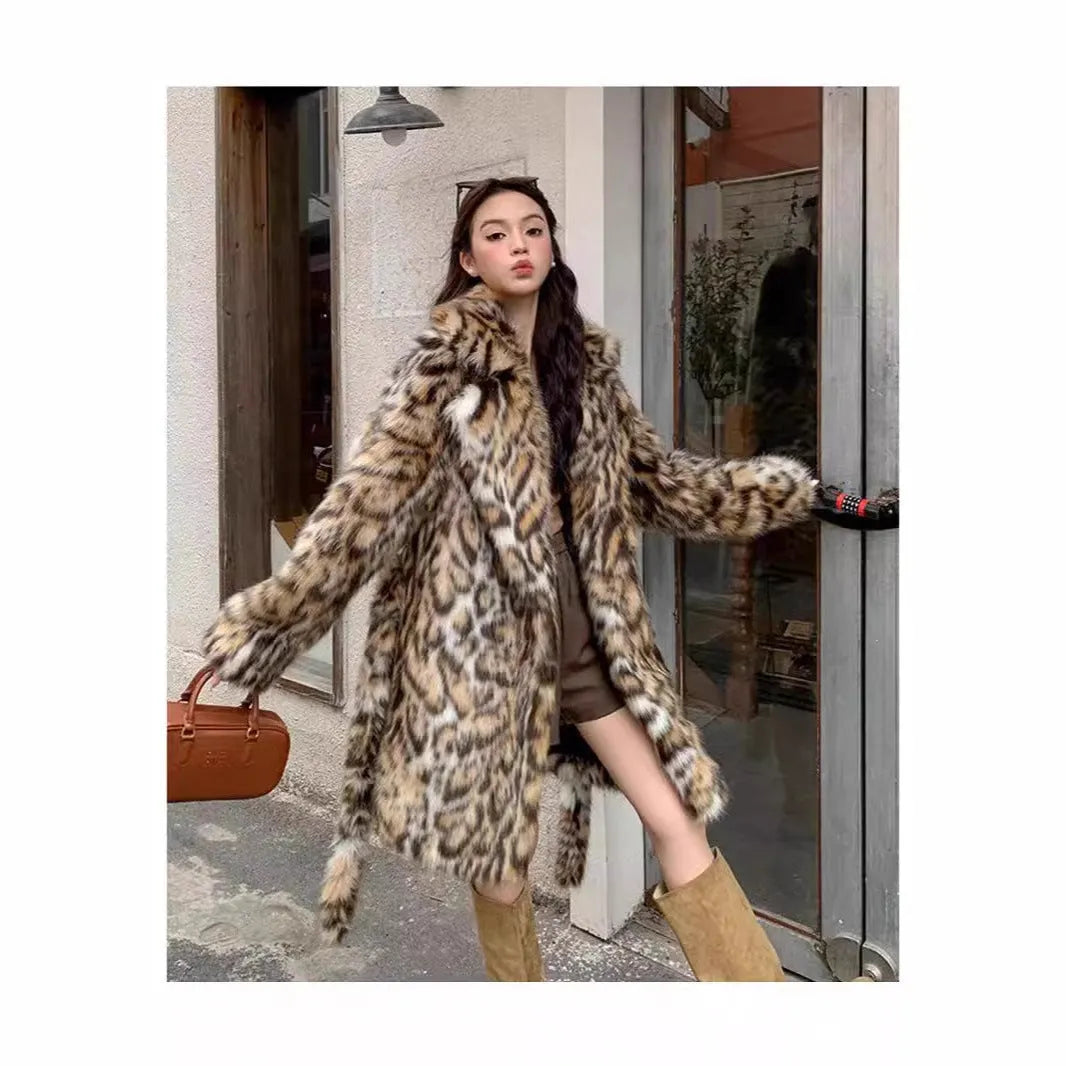 Long grey faux fur coat with a large fur collar and pockets on a model.