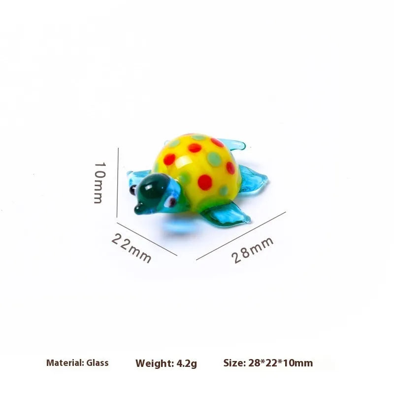 Glass geometric turtle ornament in blue head with blue shell colour variation on wooden desktop