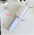 Roland purple self-cleaning hair brush with anti-static massage comb showing telescopic cleaning mechanism