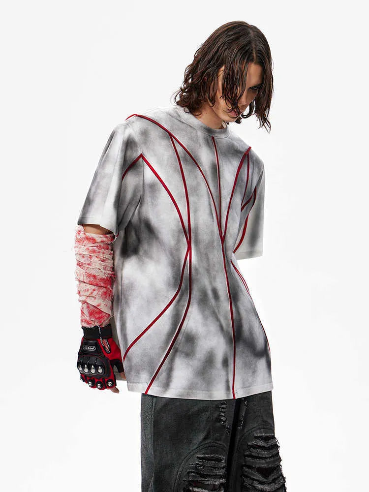 Women's grey padded shoulder t-shirt with textured patchwork design on the front.