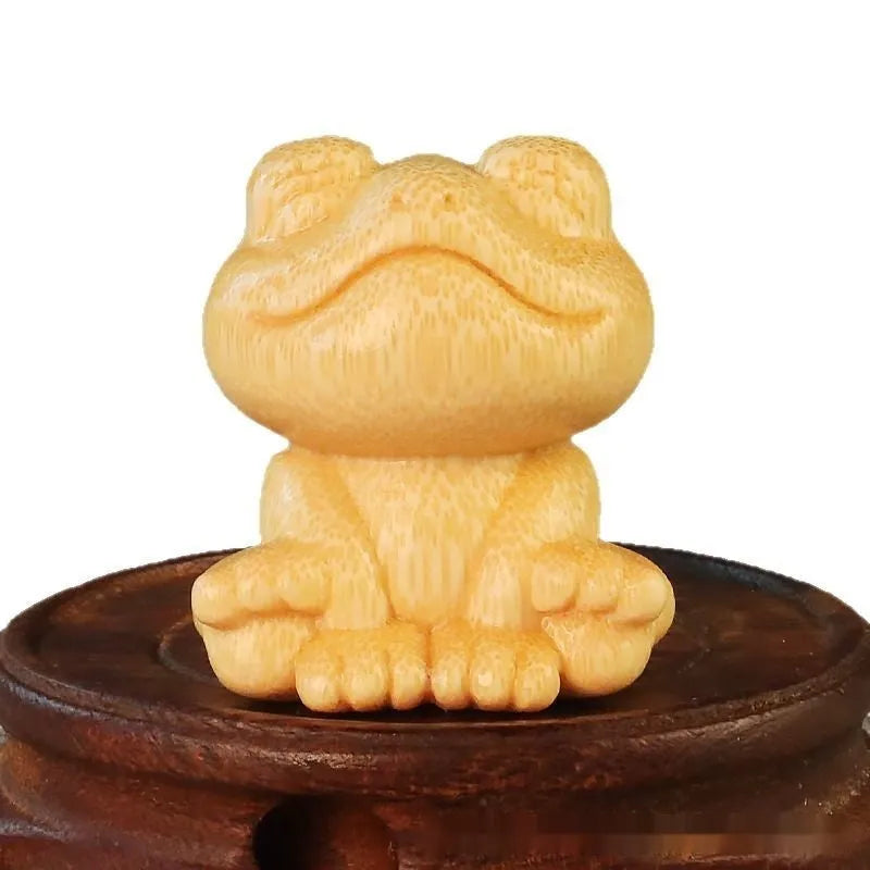 Solid bamboo smiling frog carving ornament next to a 120ml oil glove brush.