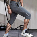 Men's cropped ice silk sports casual pants in black, shown with elastic waist and straight leg cut.
