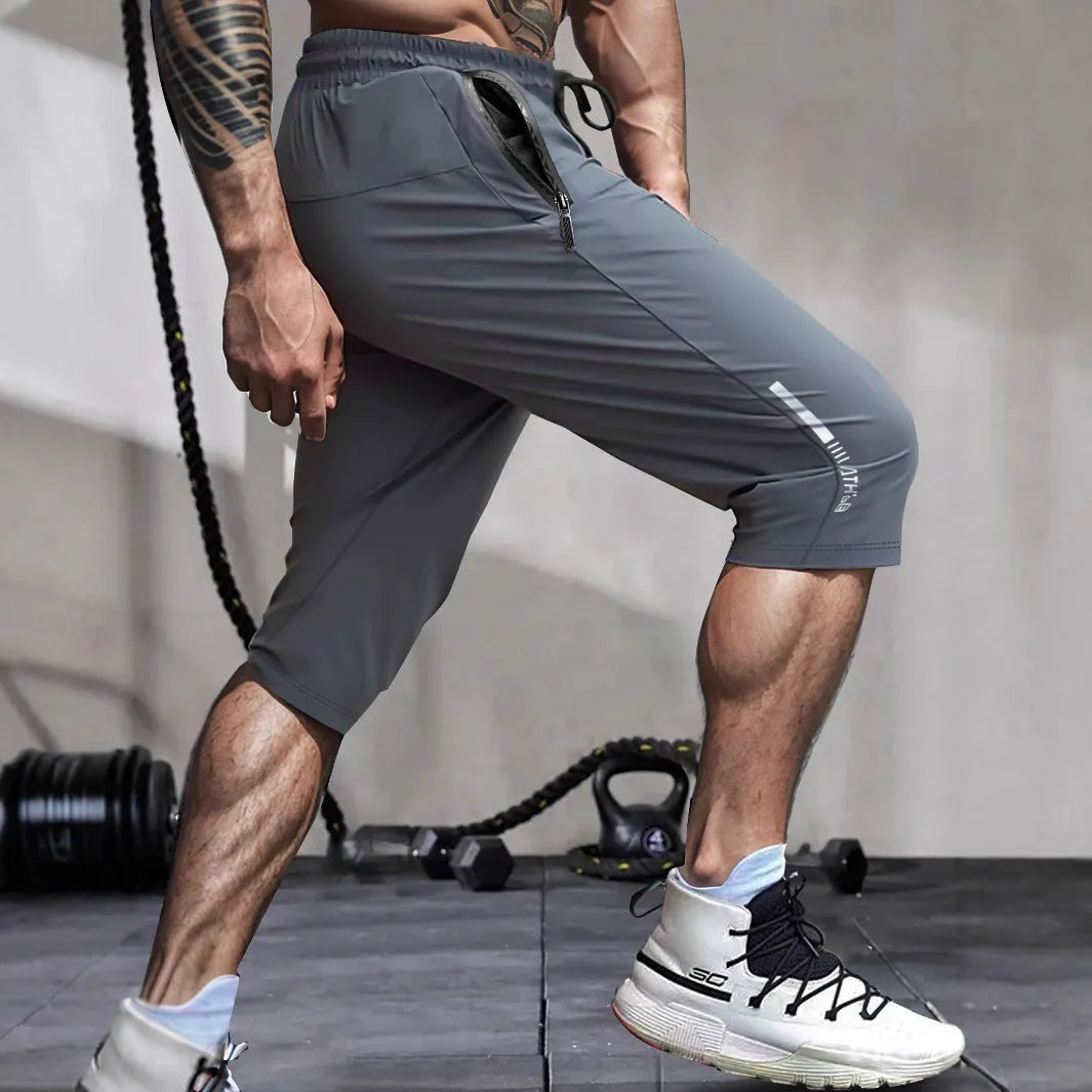 Men's cropped ice silk sports casual pants in black, shown with elastic waist and straight leg cut.