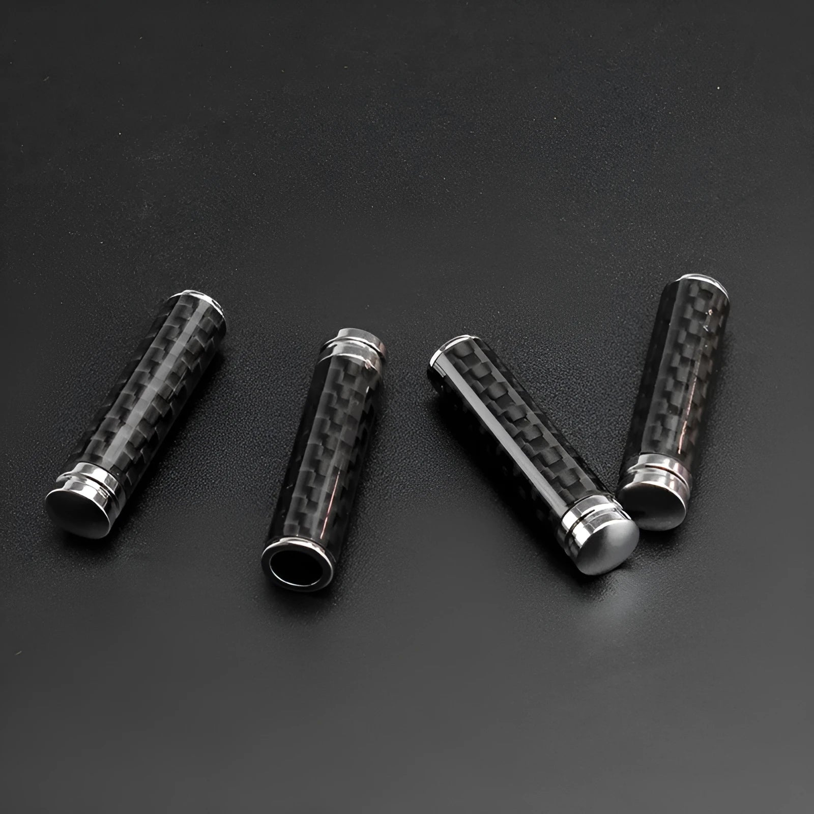 Set of four carbon fibre car door handle covers for universal fit installation.