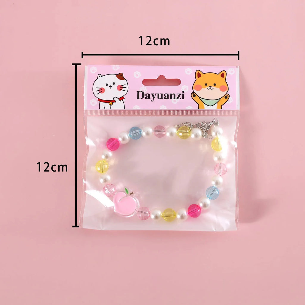 Colourful plastic bead pet necklace with small flower design on a adjustable strap.