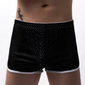 Men's grey three-point cotton boxer shorts laid flat, showing mid-waist and knitted fabric.
