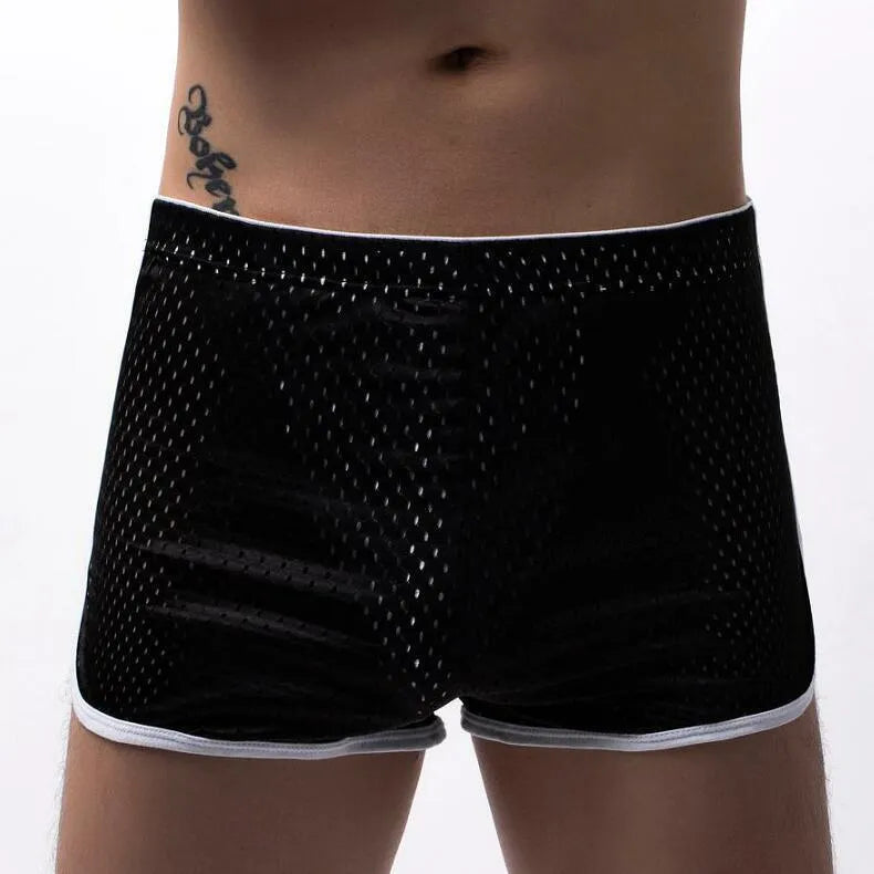 Men's grey three-point cotton boxer shorts laid flat, showing mid-waist and knitted fabric.