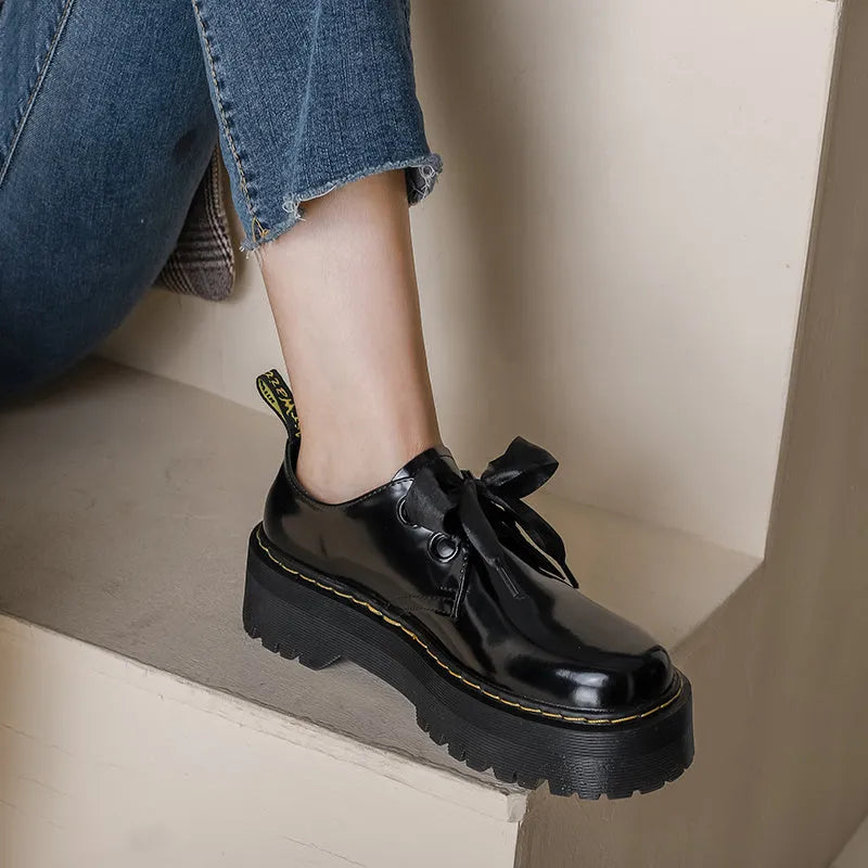 Women's thick-soled leather shoes with lace-up closure and decorative ribbon detailing