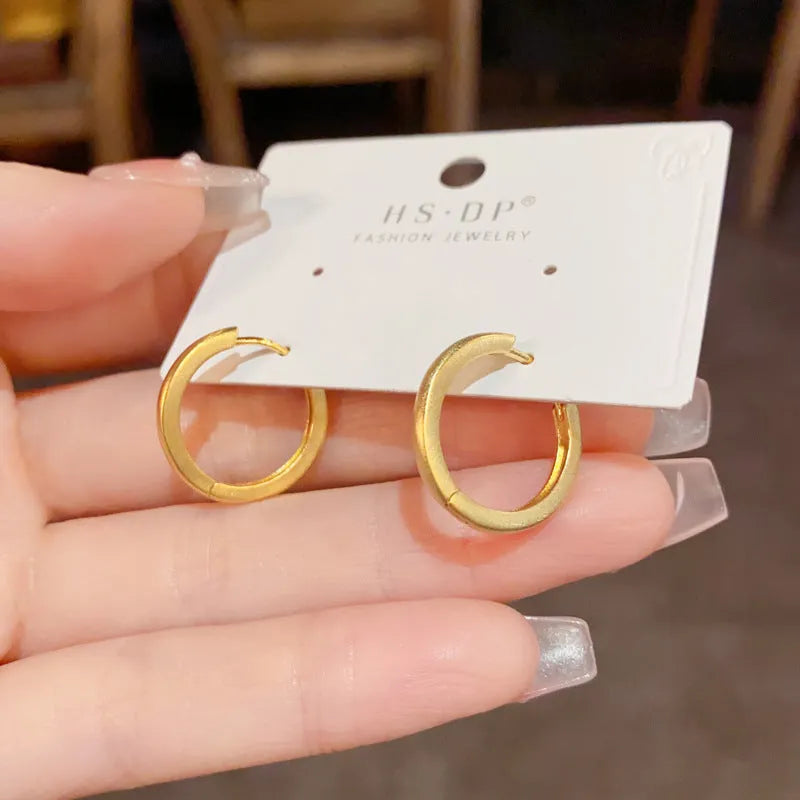 Women's geometric circle ear clip with round element in gold or silver finish, real gold plated copper minimalist jewellery