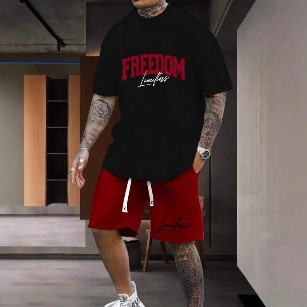 Man wearing a grey 3D printed letter design short sleeve top and matching shorts sports set.