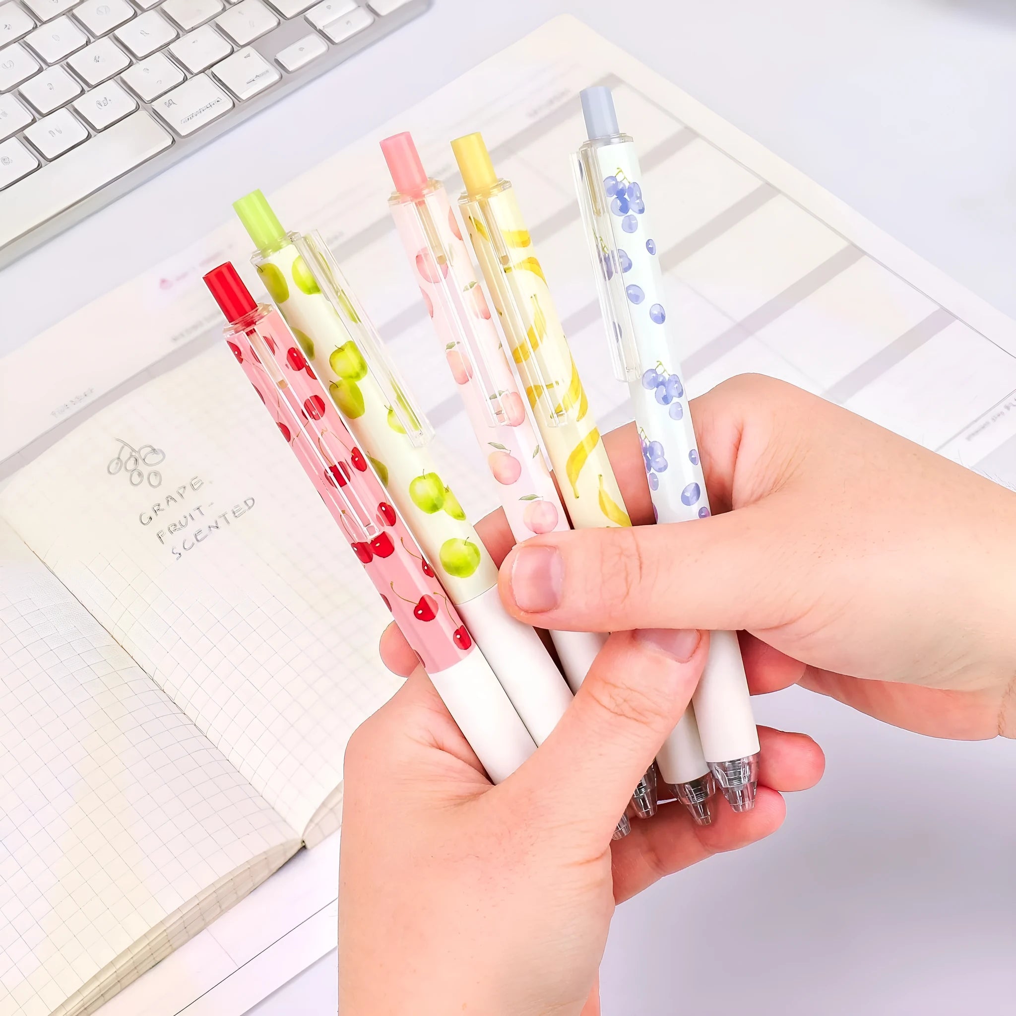 Three fruit scented press-action pens with 0.5mm quick-drying black ink refills