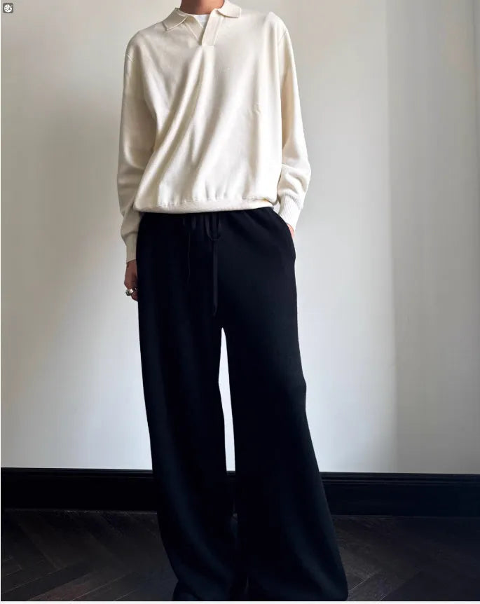 Man wearing a milky white pure wool polo sweater with a lapel collar in a loose fit.