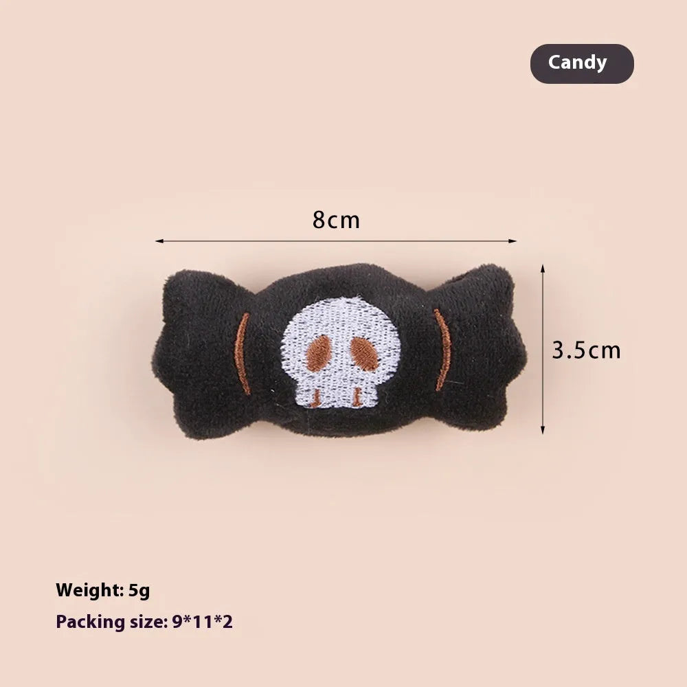 Small colourful plush cat teaser toy with candy, eyes and skull attachments