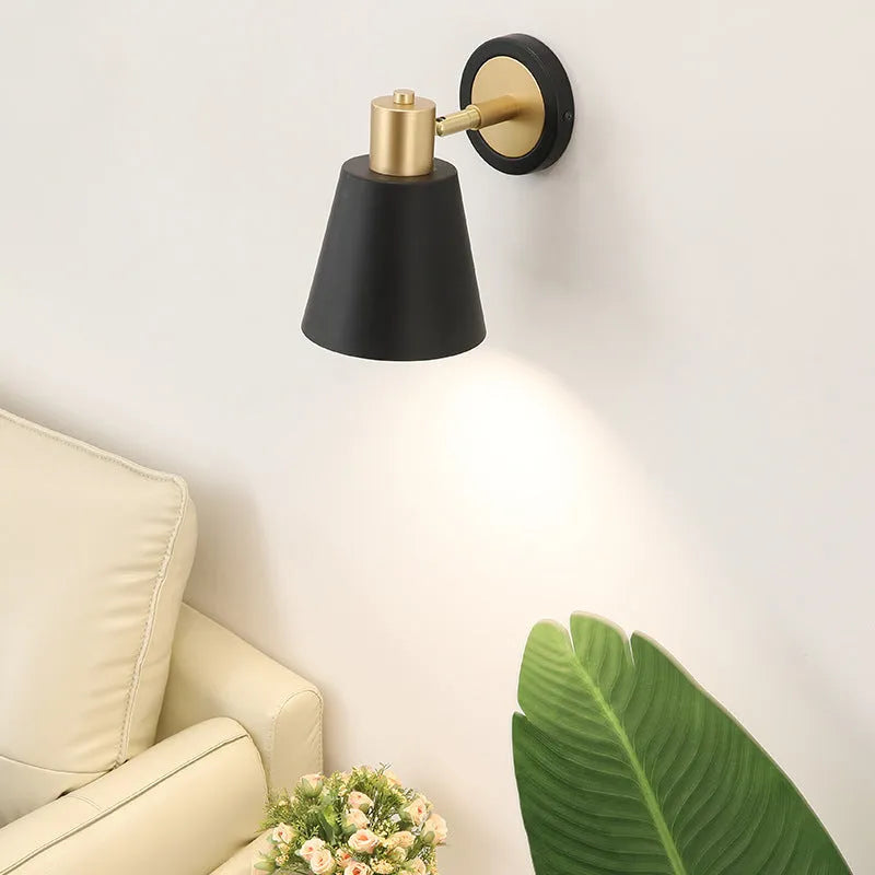 Nordic style iron wall lamp mounted beside a bed, showcasing its metal construction and adjustable light settings.
