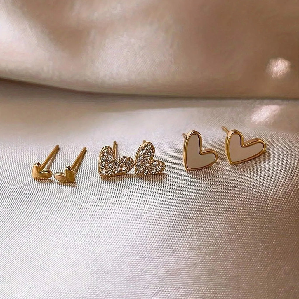 Women's three-pair heart-shaped love earrings set in gold, black, and pink colours with sweet girly style