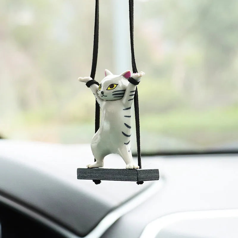 Cartoon-style resin cat pendant car ornament with adjustable rope in colour options including black, white, floral, grey, and brown.