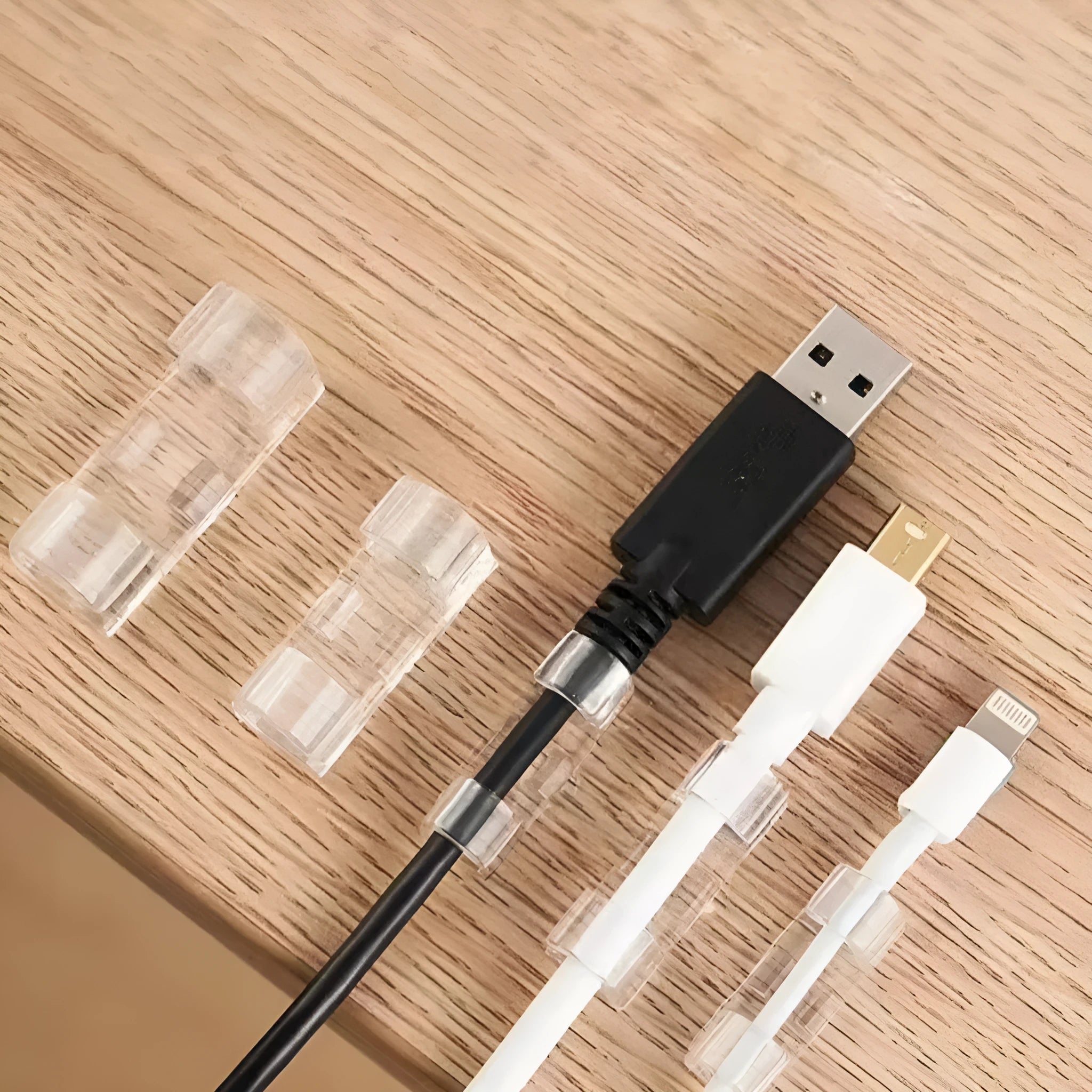 Transparent plastic self-adhesive cable management snap clips in a pack of 20.