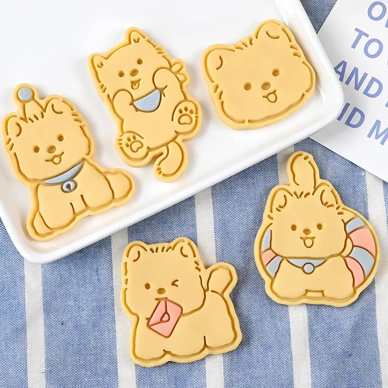Plastic 3D biscuit mould with cartoon puppy designs including birthday hats and swimming rings