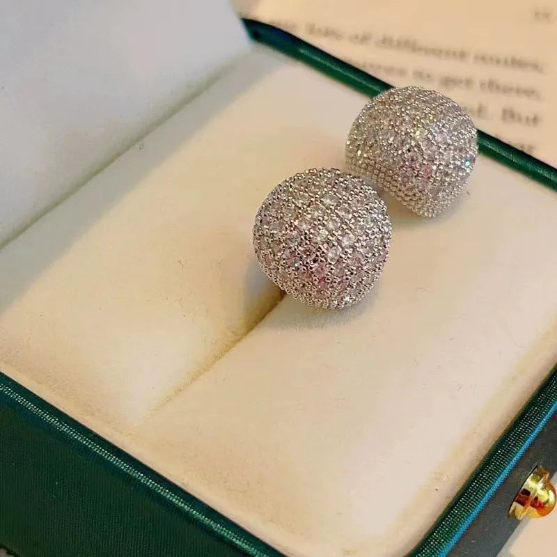 Gold geometric drop earrings with diamond patterning and sphere elements