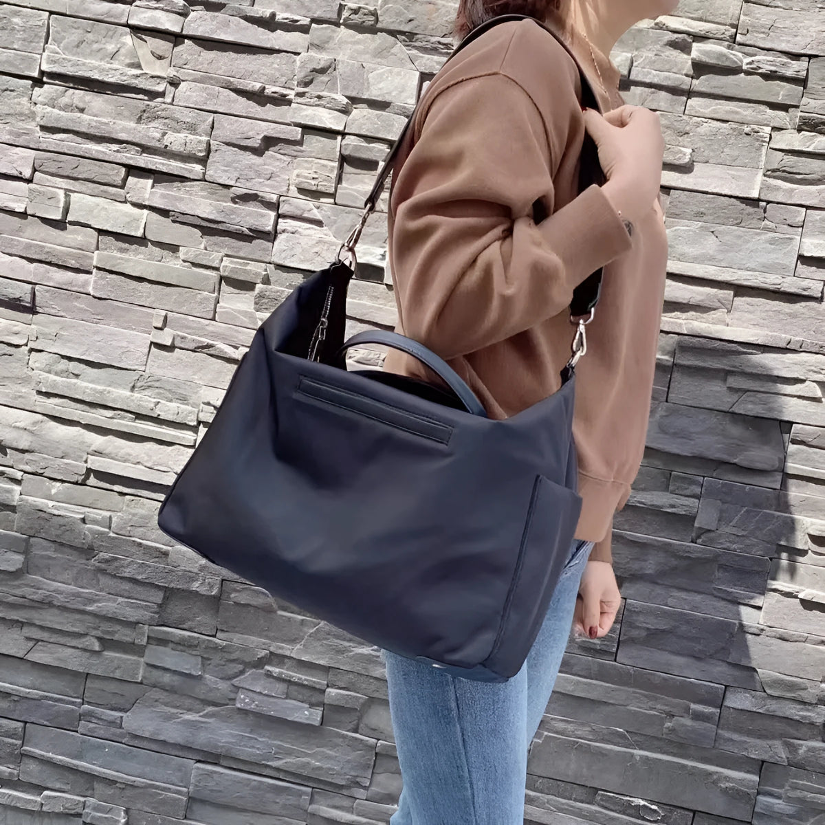 Black waterproof nylon shoulder bag with simple design and large 35cm height capacity