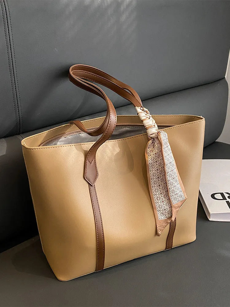Large bucket-style tote bag with crossbody strap shown in multiple colour options