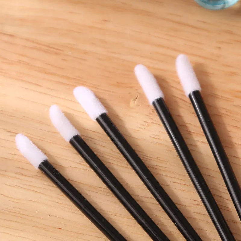 Disposable lip brushes with flocked tips and black handles in multiple colours