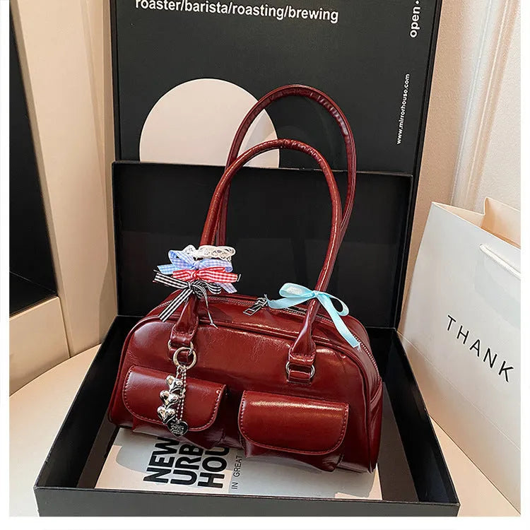 Retro one shoulder underarm pillow bag in PU leather with flap closure and double strap in black brown or red colour options
