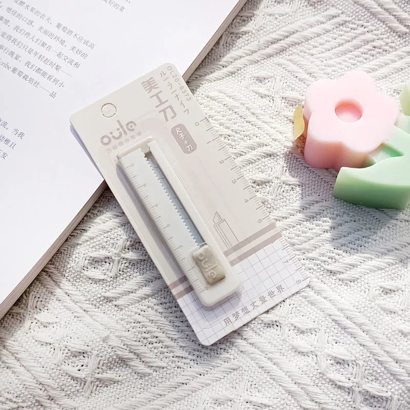 Mini portable art knife with plastic blade in five colour options showing 7.2cm length