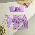 Women's pink tube top swimsuit with a large 3D flower tie and matching swim skirt.