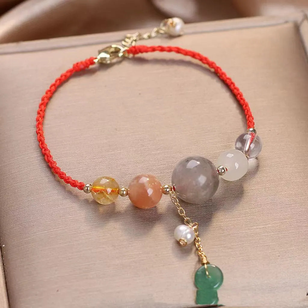 Hand-woven crystal and sequin bracelet with metal buckle clasp in red, blue, or green.