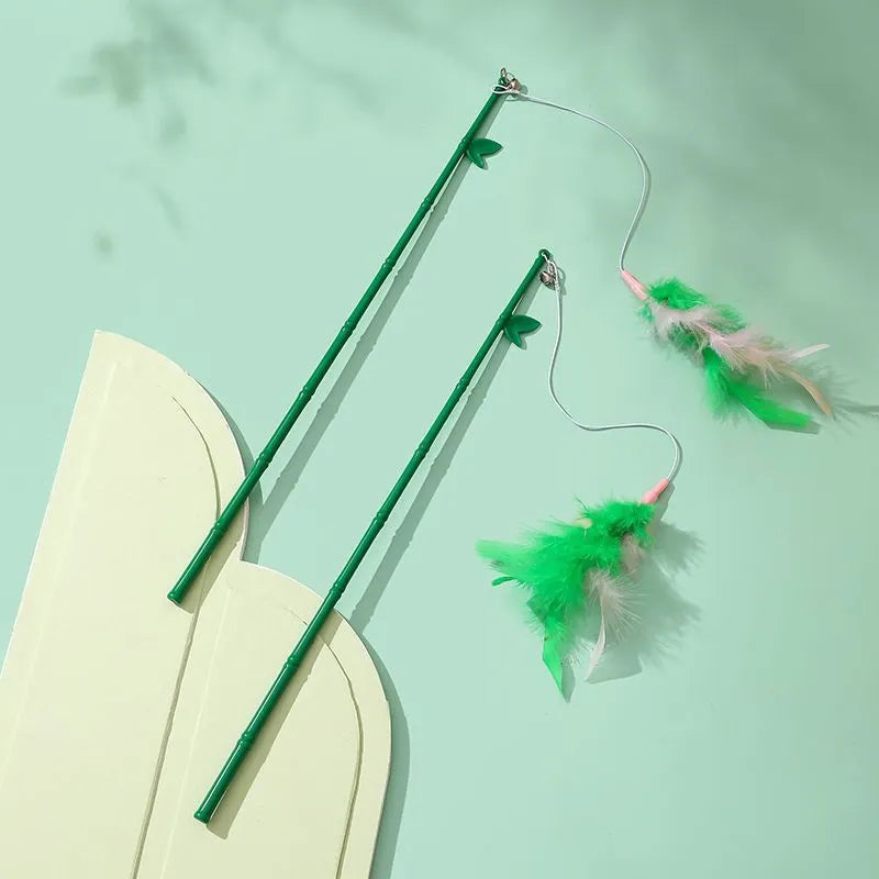 Green interactive cat feather wand toy with bell attachment and a comfortable grip handle.
