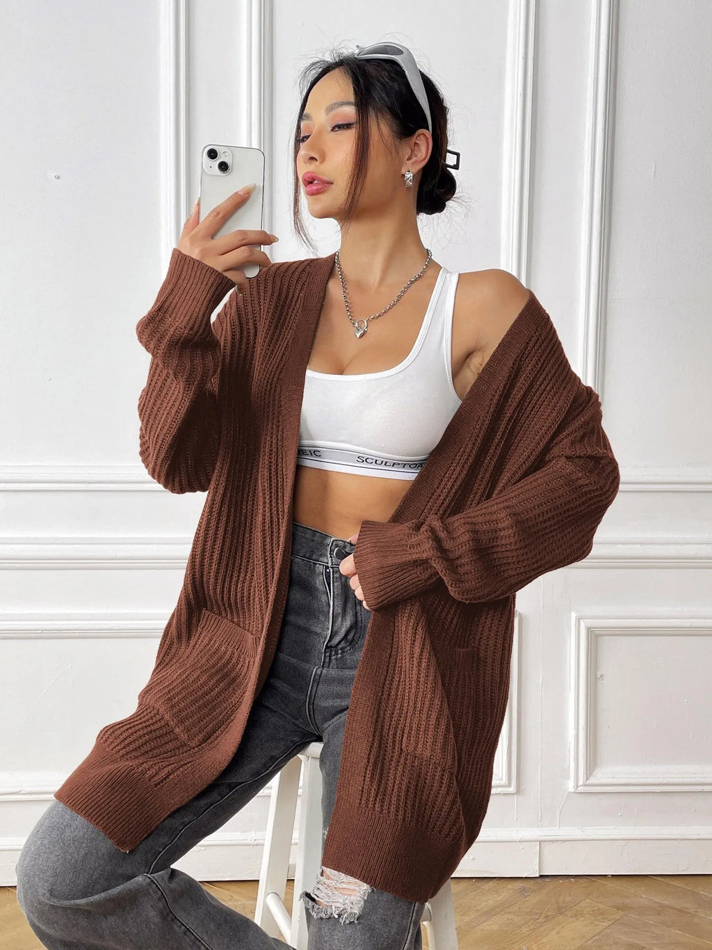 Womens double pocket acrylic cardigan in dark green colour showing mid-length design and loose fit