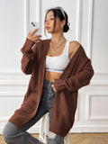 Womens double pocket acrylic cardigan in dark green colour showing mid-length design and loose fit