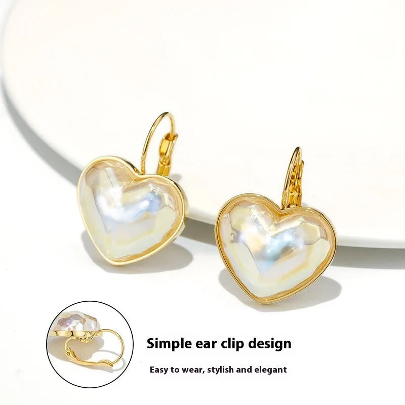 A pair of gold-coloured women's ear clips with a natural design on a white background.