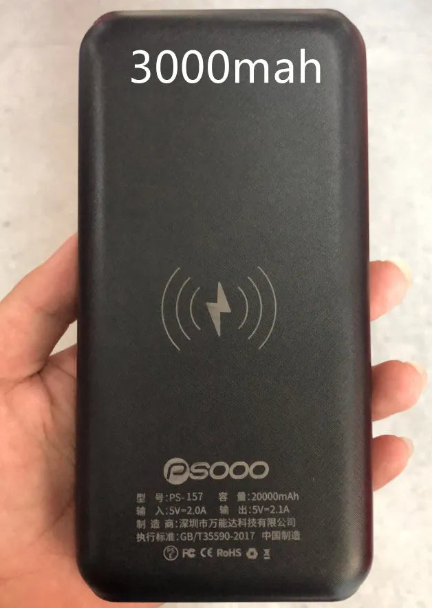 Black solar power bank with wireless charging pad, three USB ports, and an LED flashlight.