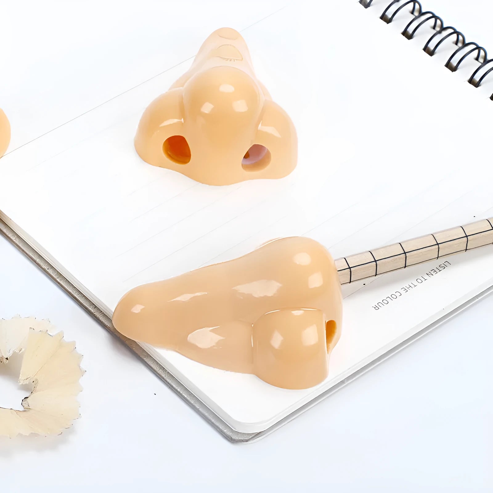Flesh-coloured plastic pencil sharpener with dual holes for different pencil sizes