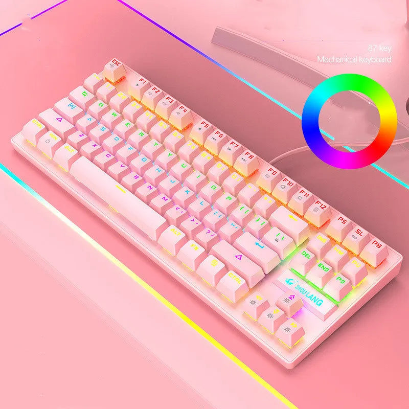 Compact mechanical gaming keyboard with RGB lighting next to laptop