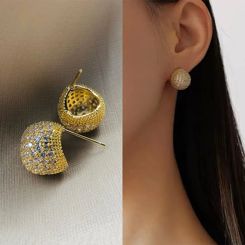Gold geometric drop earrings with diamond patterning and sphere elements