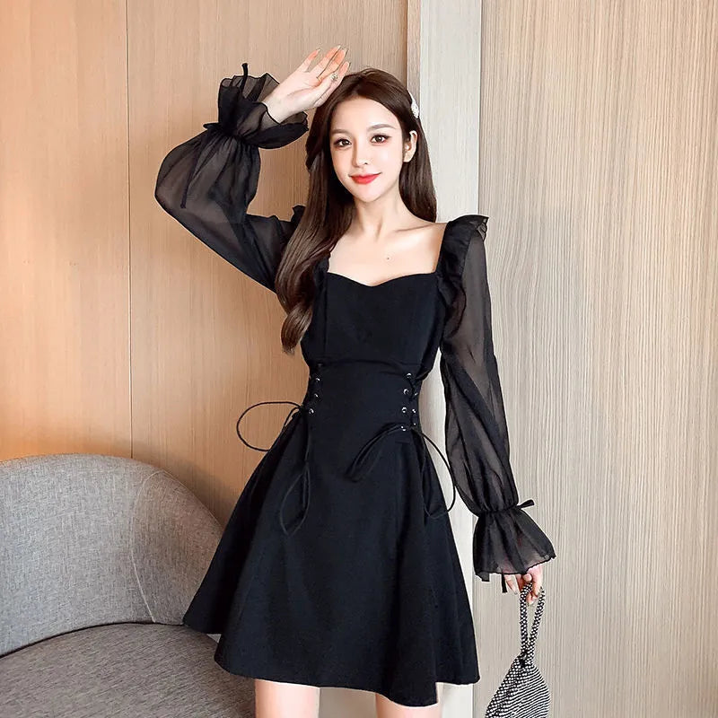 White chiffon patchwork dress on model, showing long sleeves and a long, slim-fitting skirt.