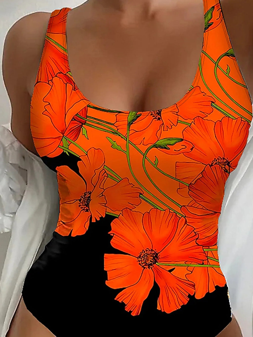 Orange floral print backless one-piece swimsuit on a model, showing slim fit.