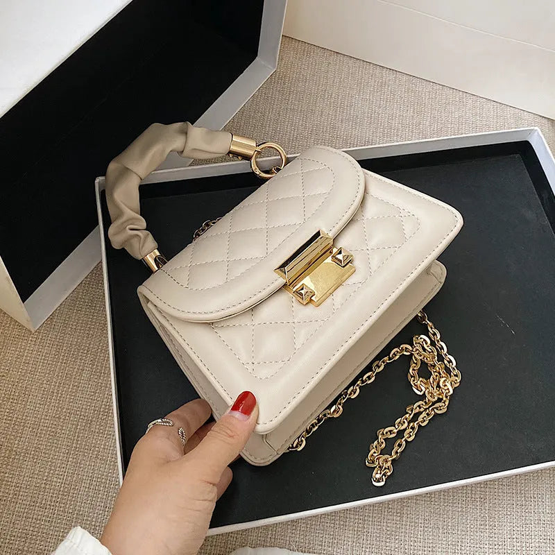 Small purple rhombus-shaped square shoulder bag with a long crossbody strap