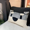 Grey and white West Highland puppy decorative cushion on sofa