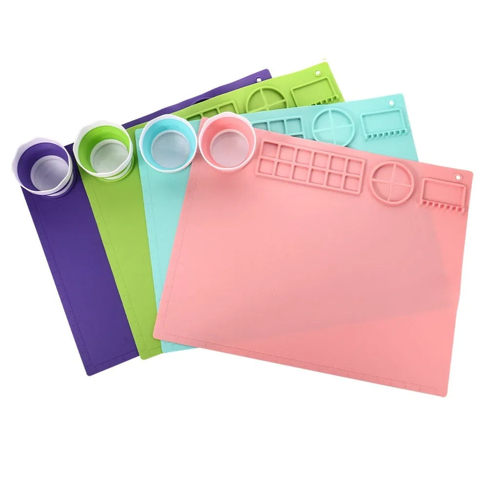 Silicone double bowl painting mat for watercolour art in various colours on a table