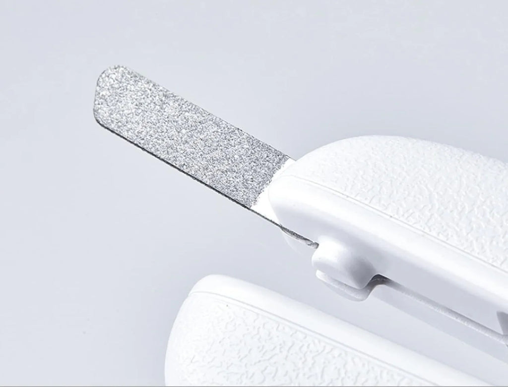 White LED pet nail clipper with transparent anti-splash guard open, showing triangular stainless steel blade