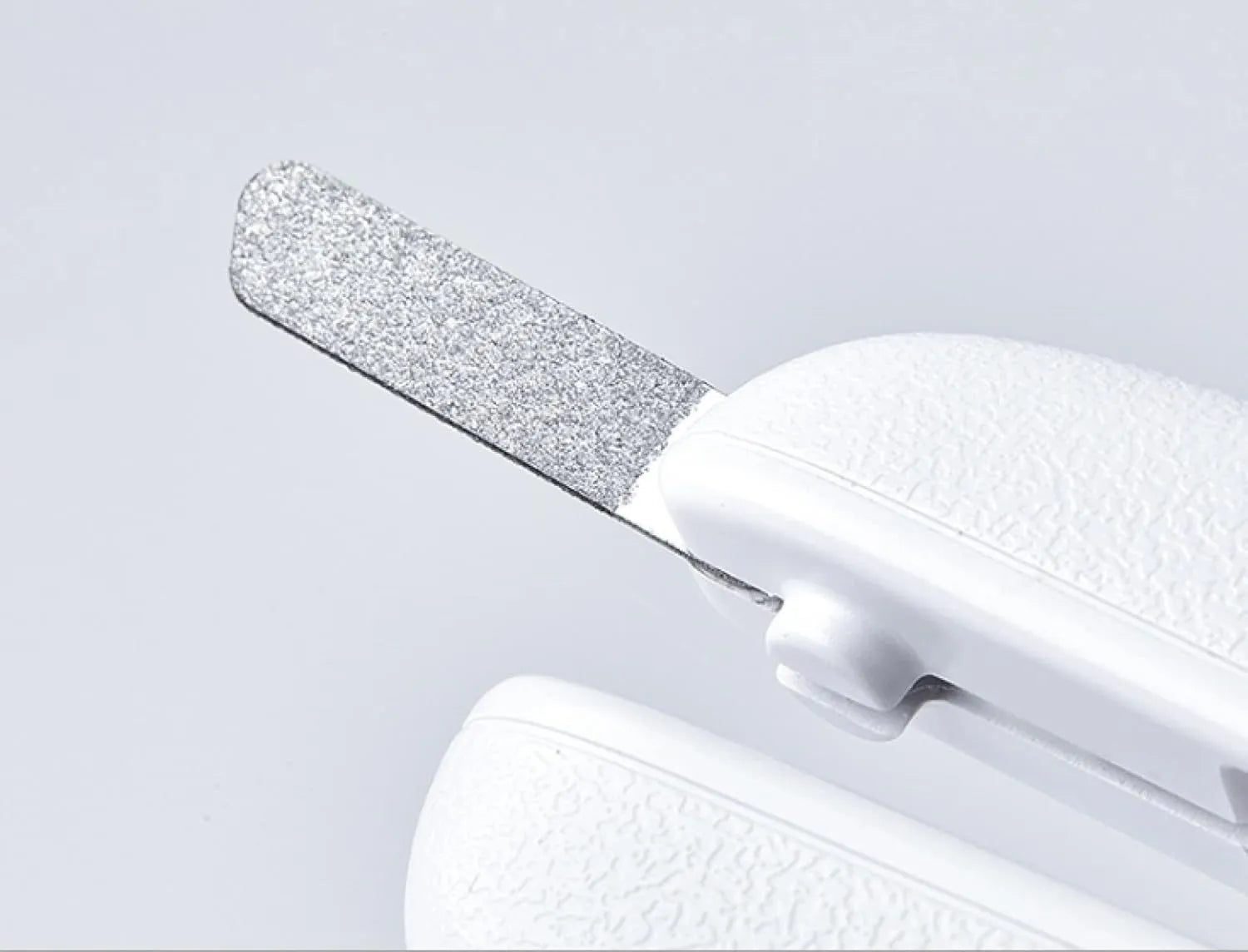 White LED pet nail clipper with transparent anti-splash guard open, showing triangular stainless steel blade