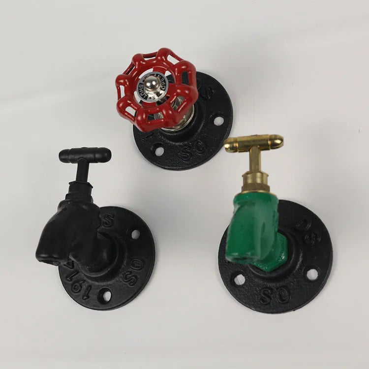 Metal water pipe style towel hook mounted on a wall in black, green, or red.
