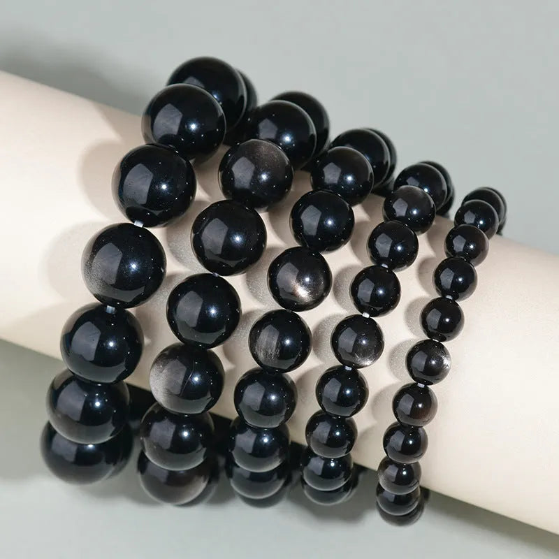 Hand-woven obsidian bracelet with round crystal beads in multiple colour options and sizes