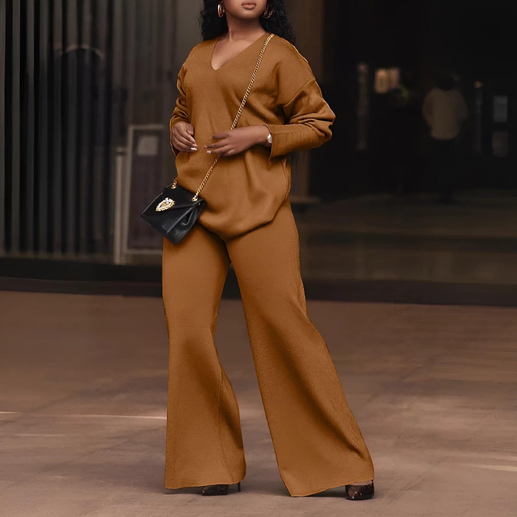 Brown women's suede velvet two-piece suit with long sleeves and full-length trousers on a model.