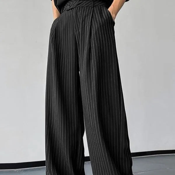 Men's black vertical striped pleated casual trousers showing elastic waistband and leg detail